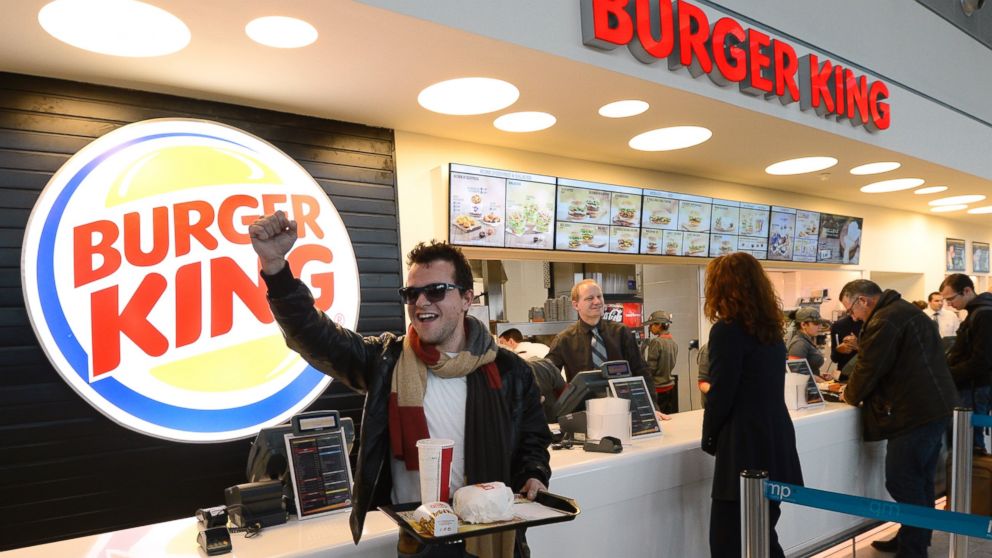 PHOTO: A customer reacts after being served at the Burger King fast food restaurant in Marseille's airport, in Marignane, southern France, on Dec. 22, 2012.