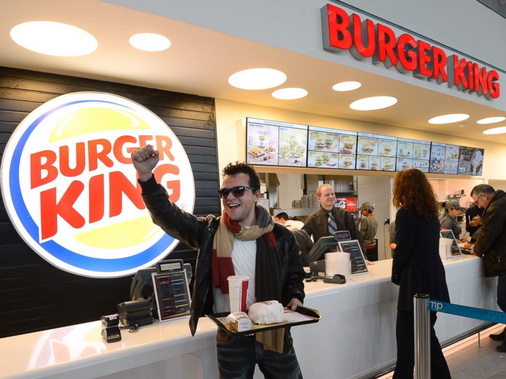 PHOTO: A customer reacts after being served at the Burger King fast food restaurant in Marseilles airport, in Marignane, southern France, on Dec. 22, 2012.