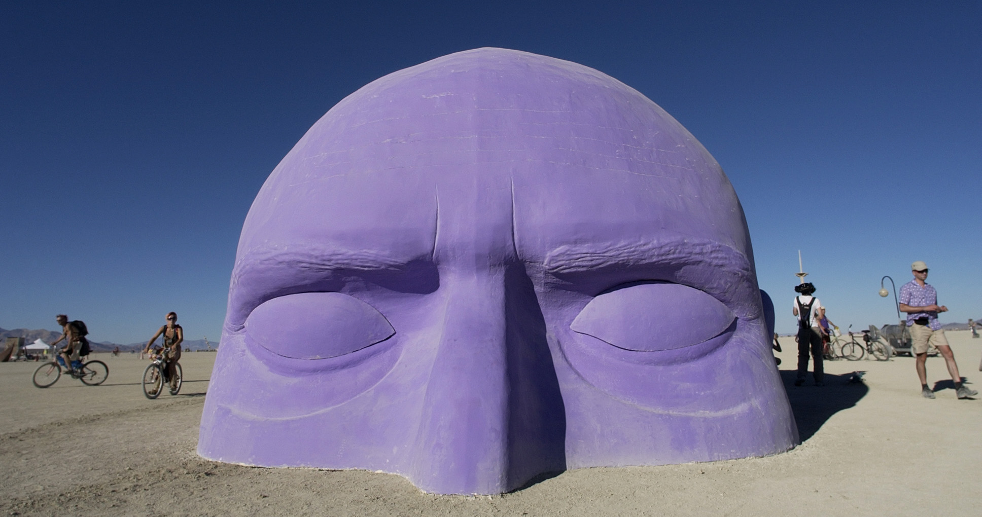 PHOTO:A giant head, one of many art installlations dotting the playa at Burning Man, appears to emerge from the sand, Aug. 30, 2005. 