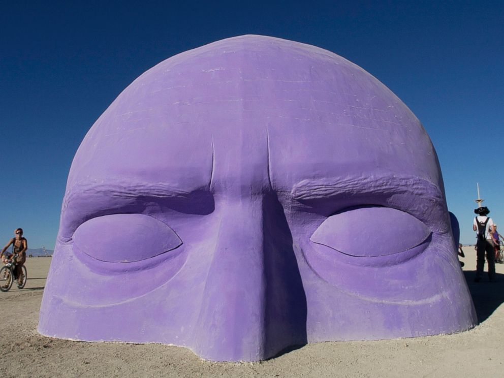 PHOTO:A giant head, one of many art installlations dotting the playa at Burning Man, appears to emerge from the sand, Aug. 30, 2005.