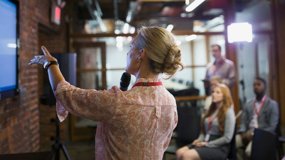 PHOTO: A businesswoman speaks in front of a small crowd in an undated stock photo.