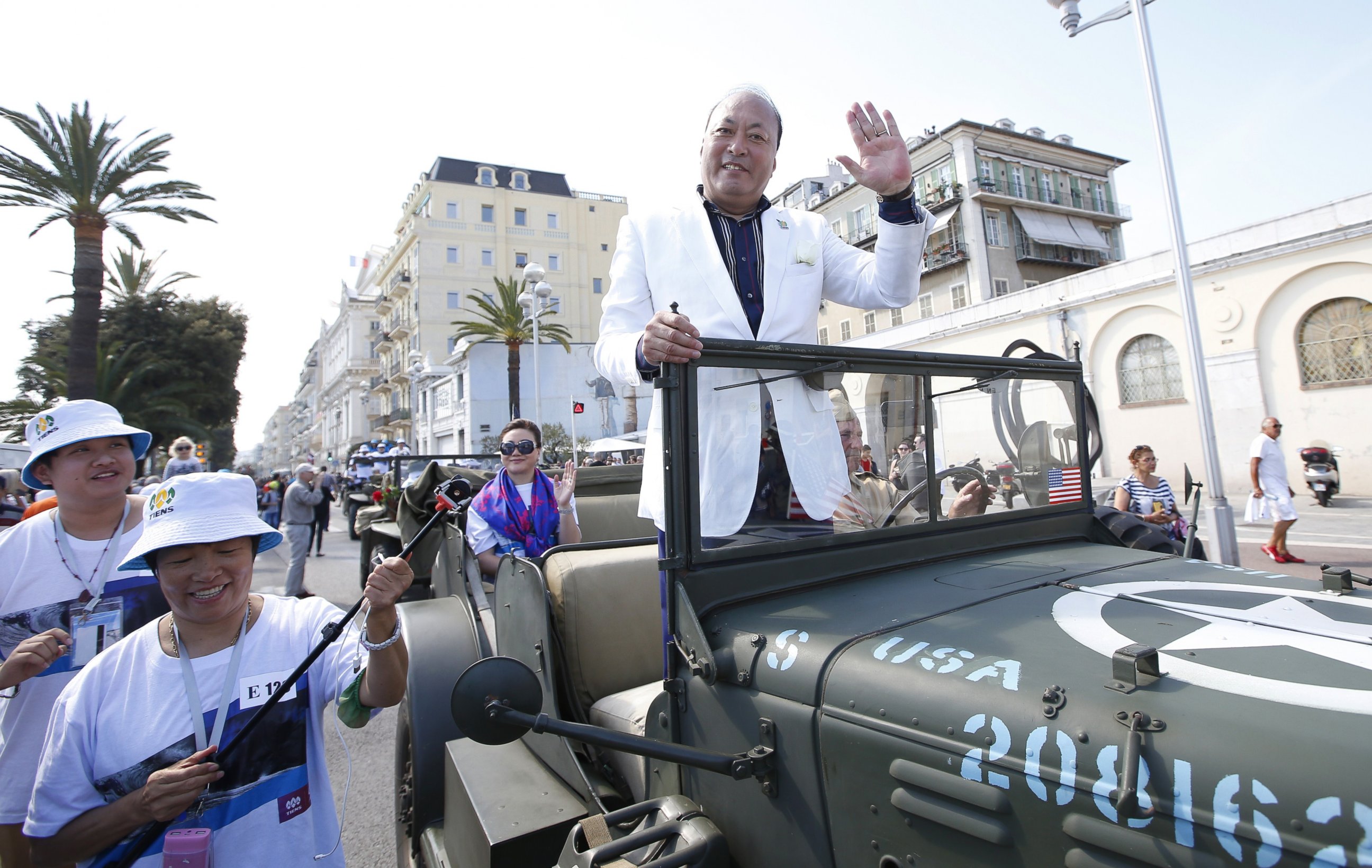 PHOTO: Li Jinyuan, CEO of 'Tiens' rides in a parade on May 8, 2015 in Nice, France as part of the two-day celebration weekend for the 20th anniversary of his company.