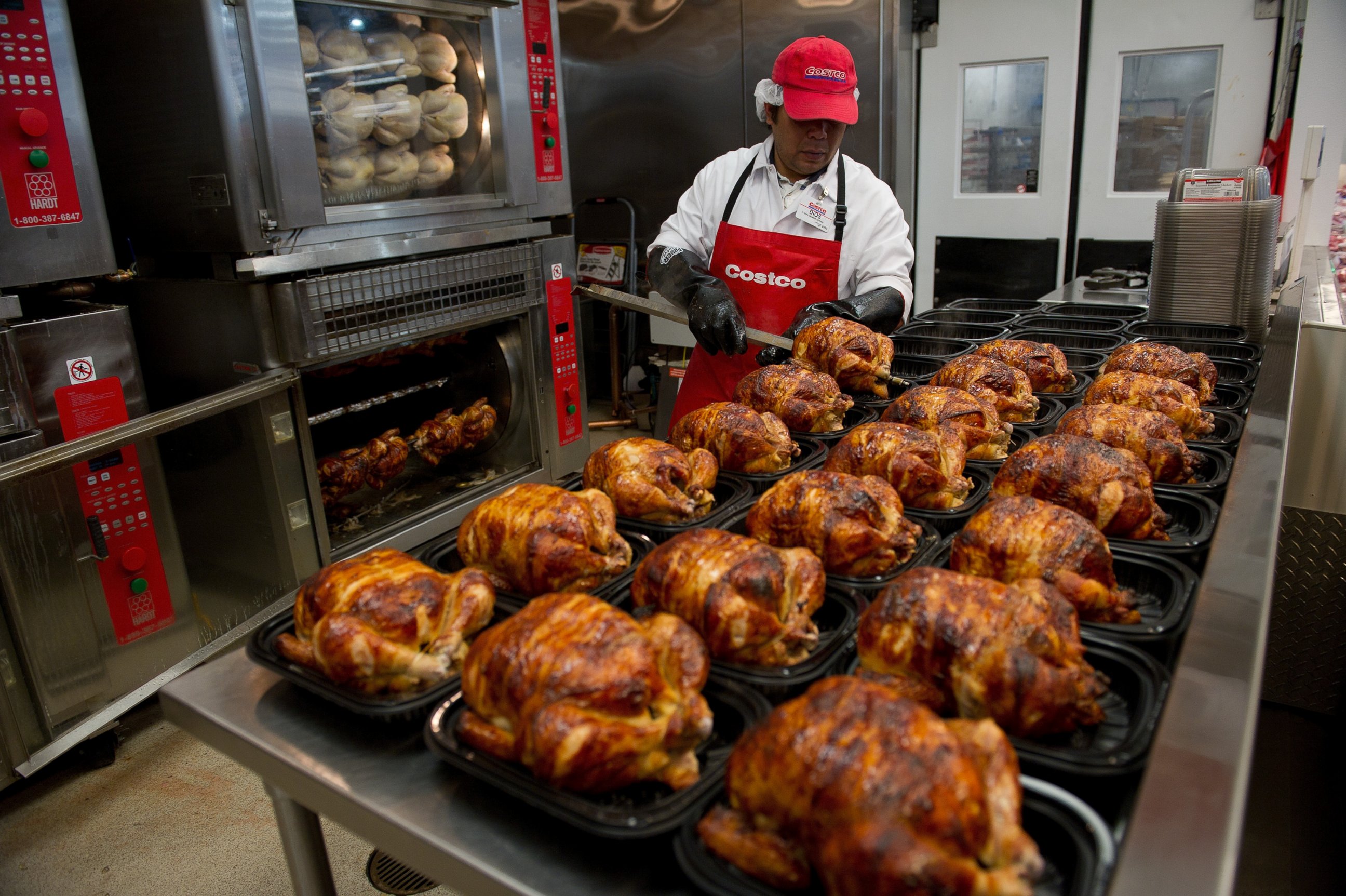PHOTO: A service deli worker places cooked rotisserie chickens in containers at a Costco store in San Francisco, Calif. on Dec. 6, 2011.