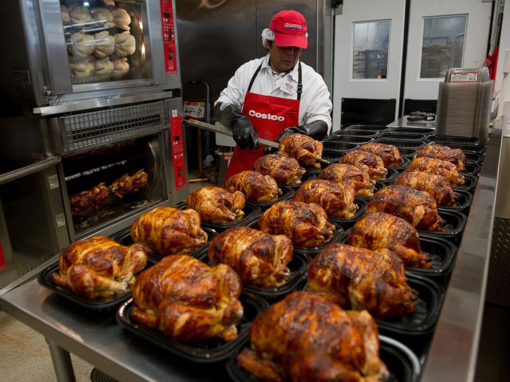 PHOTO: A service deli worker places cooked rotisserie chickens in containers at a Costco store in San Francisco, Calif. on Dec. 6, 2011.