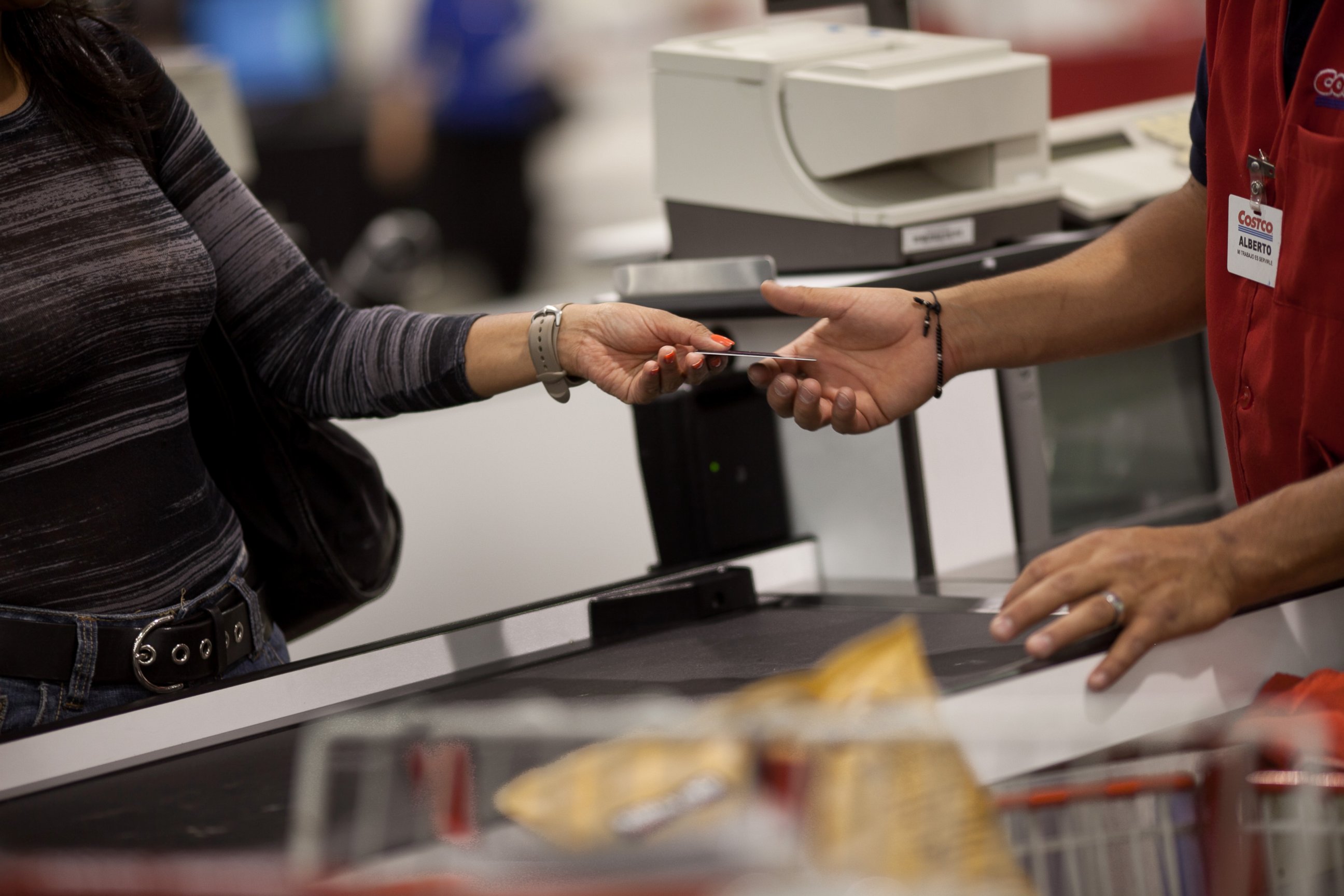 PHOTO: A customer hands the cashier her membership card to make purchases at the Costco outside of Mexico City on May 21, 2012.