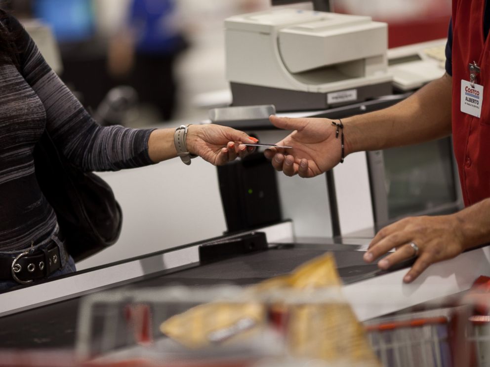 PHOTO: A customer hands the cashier her membership card to make purchases at the Costco outside of Mexico City on May 21, 2012.