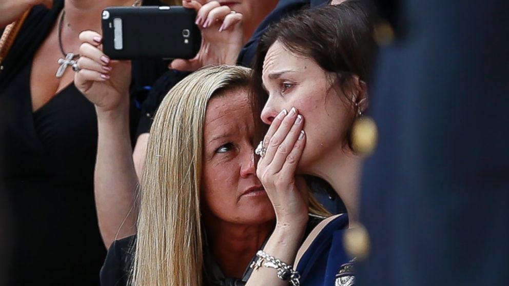 PHOTO: Family members console Kathleen Goforth, the widow of Harris County Sherrif Deputy Darren Goforth, following his funeral at Second Baptist Church on Sept. 4, 2015, in Houston, Texas. 