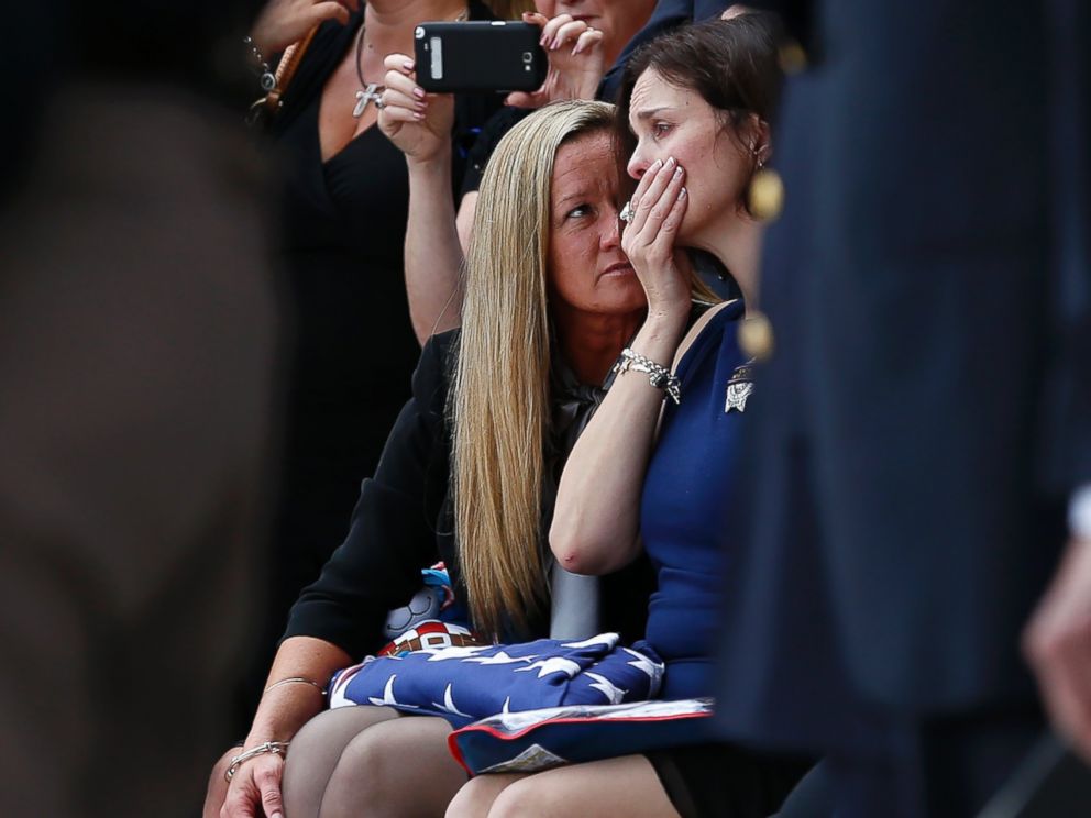 PHOTO: Family members console Kathleen Goforth, the widow of Harris County Sherrif Deputy Darren Goforth, following his funeral at Second Baptist Church on Sept. 4, 2015, in Houston, Texas.