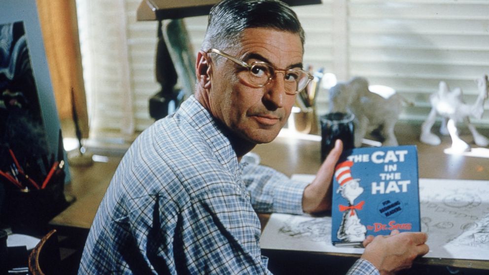 PHOTO: Author and illustrator Theodor Seuss Geisel sits at his drafting table in his home office with a copy of his book, "The Cat in the Hat" in La Jolla, Calif., April 25, 1957.