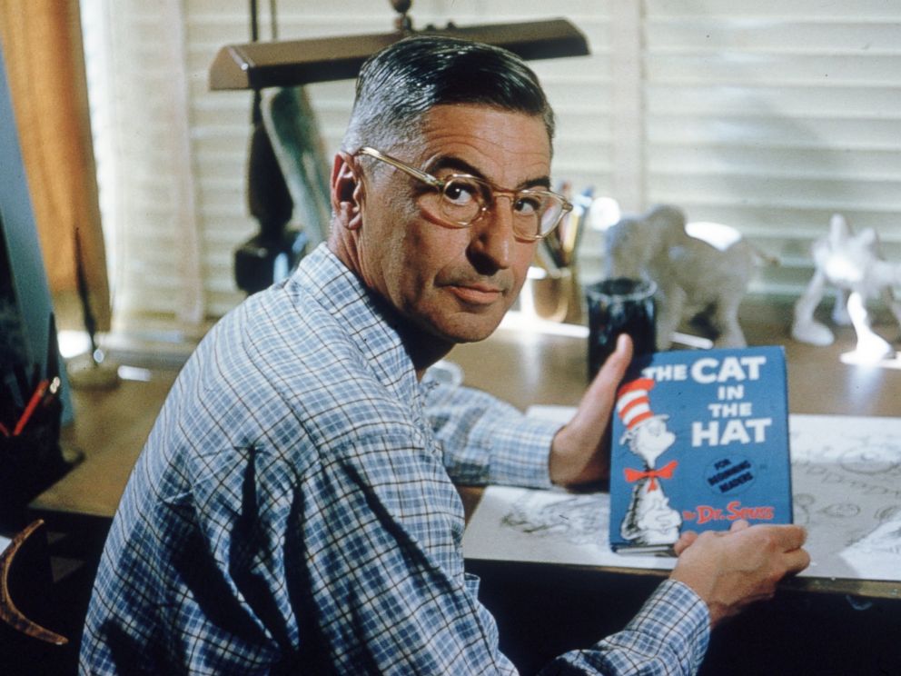 PHOTO: Author and illustrator Theodor Seuss Geisel sits at his drafting table in his home office with a copy of his book, The Cat in the Hat in La Jolla, Calif., April 25, 1957.
