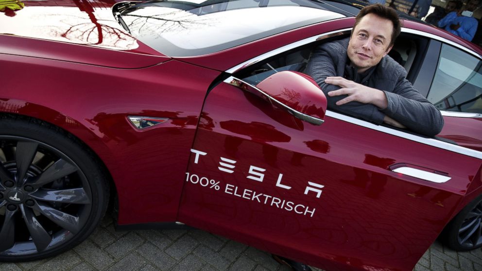 PHOTO: Elon Musk, co-founder and CEO of Tesla Motors, poses with a Tesla during a visit to Amsterdam on January 31, 2014.