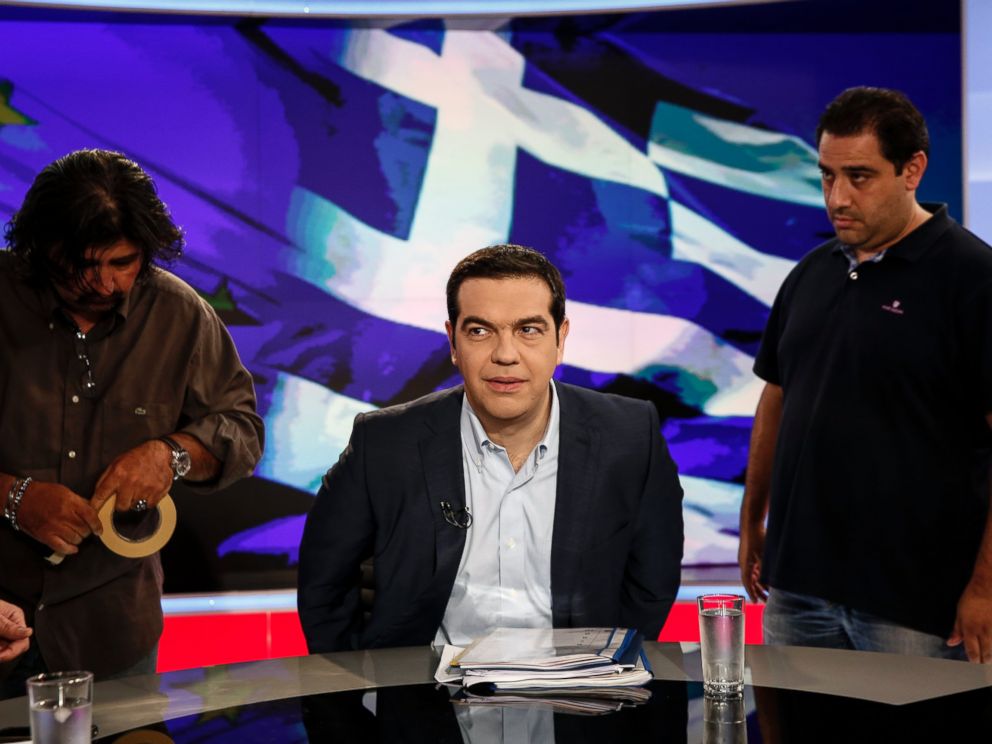 PHOTO: Alexis Tsipras, Greeces prime minister, center, takes his seat for a televised interview in Athens, Greece, June 29, 2015.