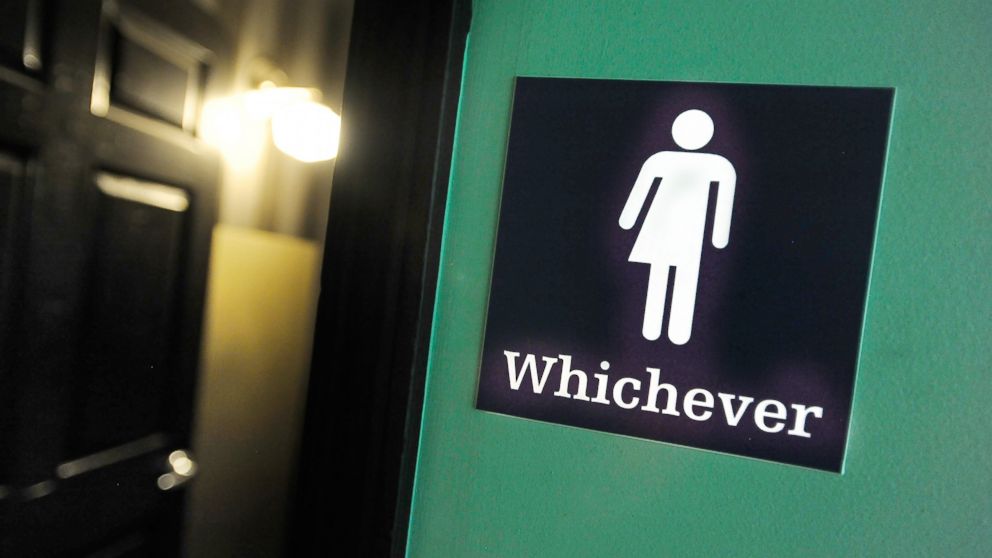 A gender neutral sign is posted outside a bathrooms at Oval Park Grill on May 11, 2016 in Durham, North Carolina.
