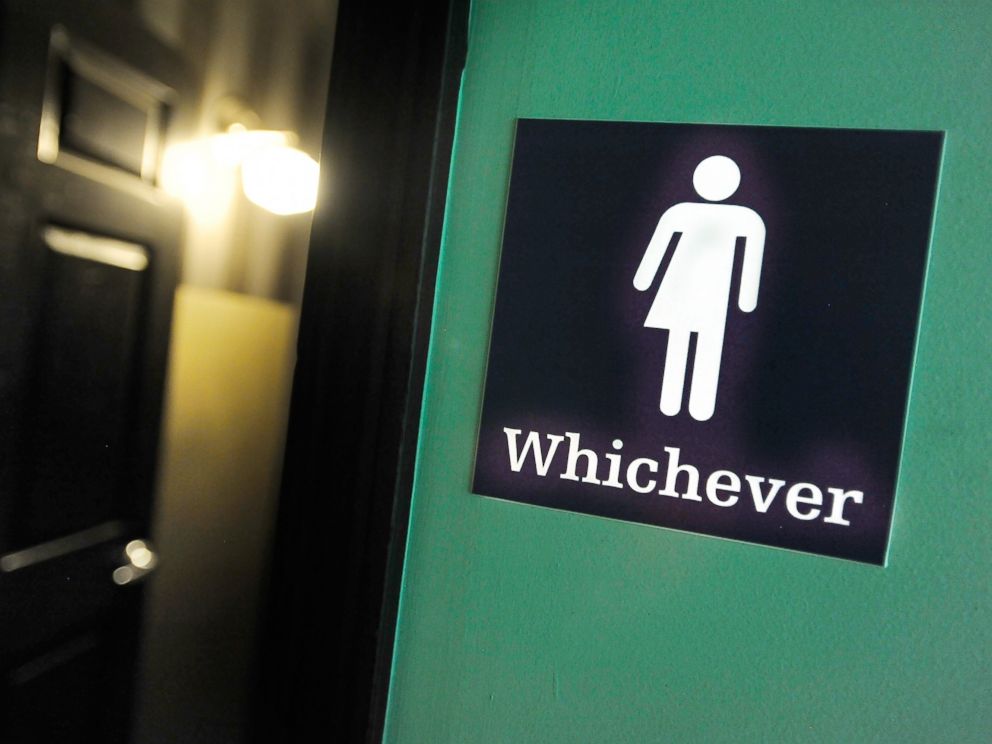 PHOTO: A gender neutral sign is posted outside a bathrooms at Oval Park Grill on May 11, 2016 in Durham, North Carolina.