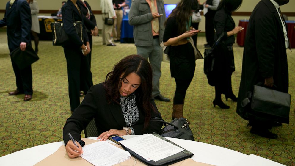 Veronica Floyd fills out a job application at a National Career Fairs job fair in Arlington, Va., Jan. 30, 2013. 