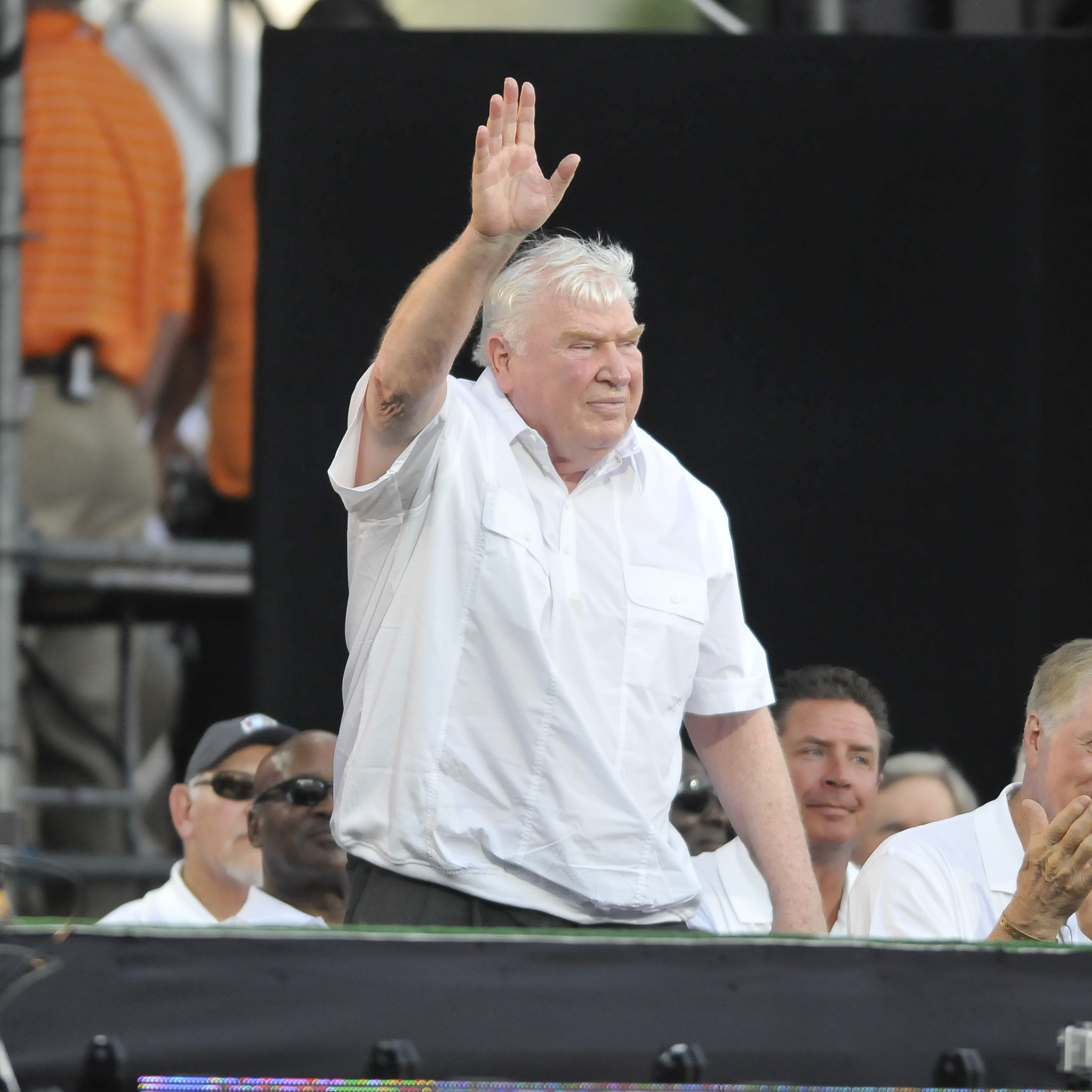 PHOTO: Former NFL coach John Madden waves to the crowd after being introduced before the 2012 Pro Football Hall of Fame Enshrinement ceremony on August 4, 2012, at Fawcett Stadium in Canton, Ohio.