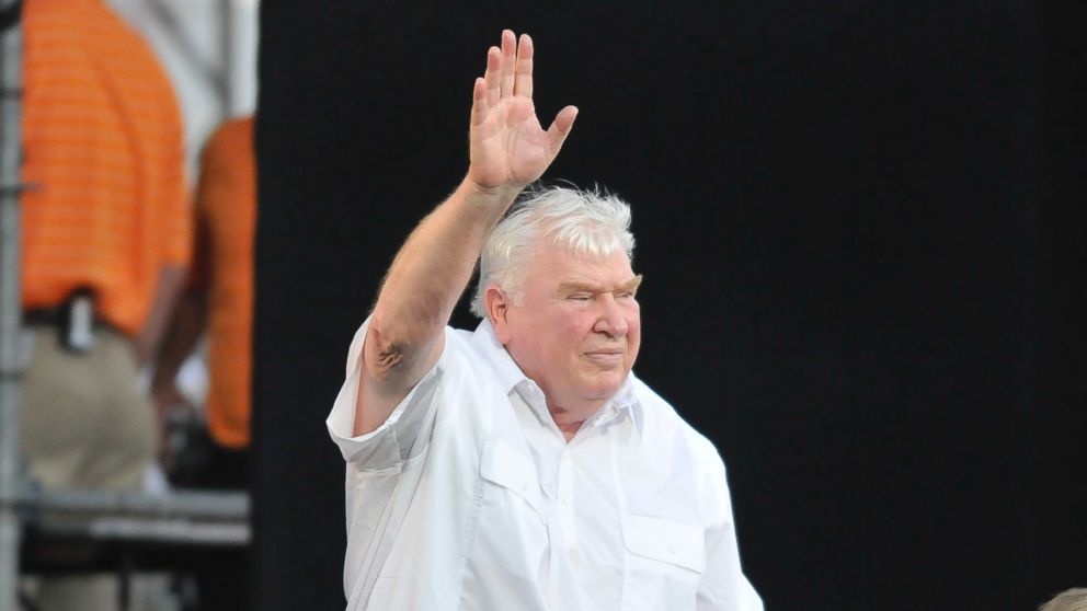 PHOTO: Former NFL coach John Madden waves to the crowd after being introduced before the 2012 Pro Football Hall of Fame Enshrinement ceremony on August 4, 2012, at Fawcett Stadium in Canton, Ohio.
