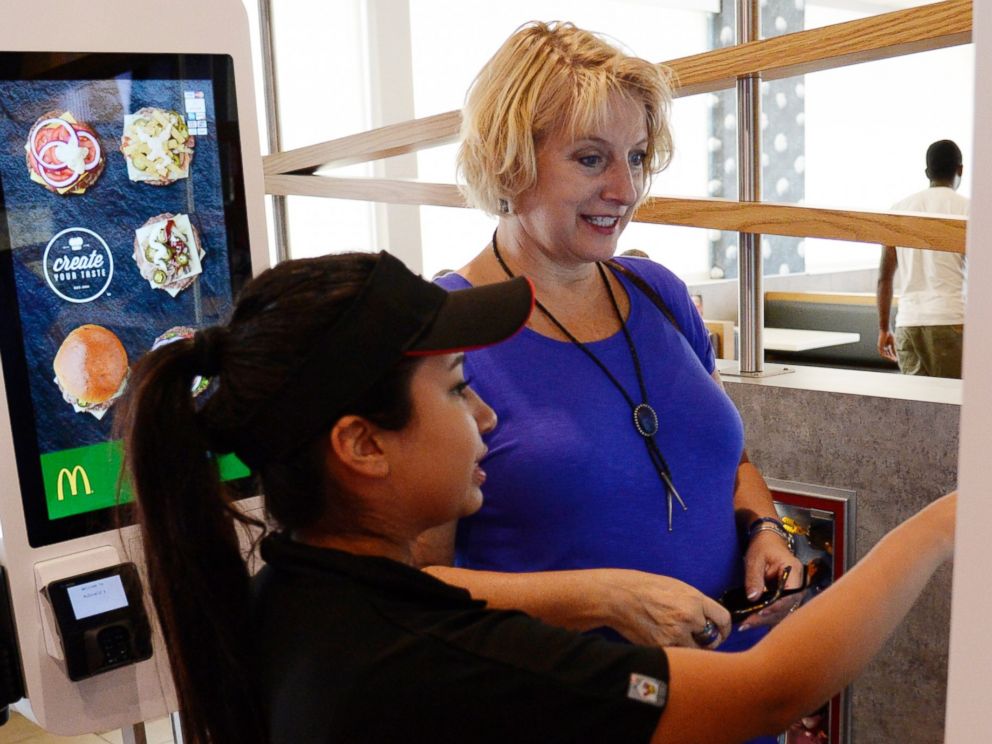 PHOTO: McDonalds worker Jacqueline Garcia helps a customer order a custom meal from the the Create Your Taste kiosk at special McDonalds restaurant in Aurora, Colo., Aug. 26, 2015.