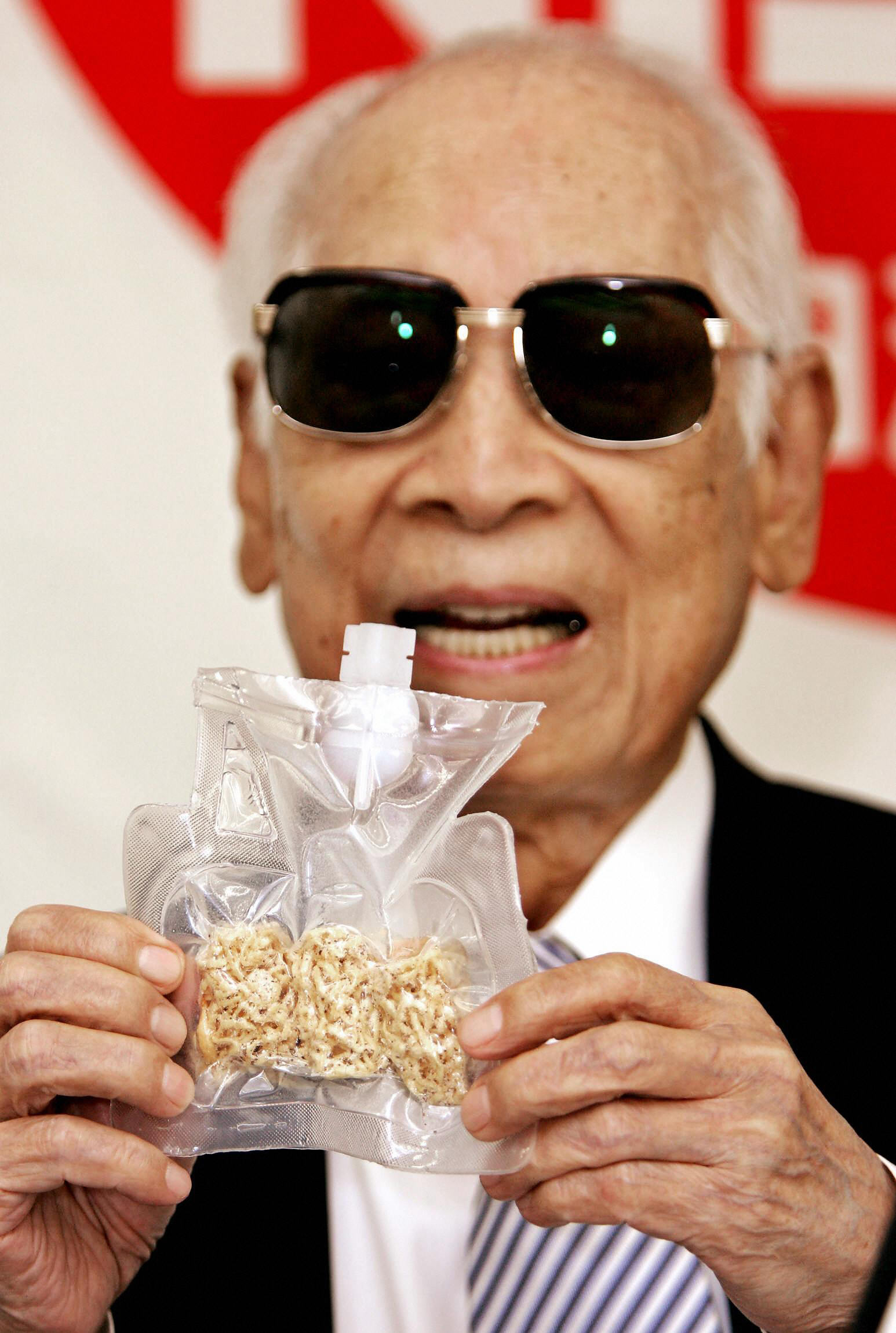 PHOTO: Momofuku Ando holds up a package of instant noodles for astronauts called "Space Ram" during a press conference at the company's Instant Noodle Museum in Osaka, July 27, 2005.