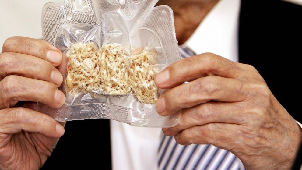 PHOTO: Momofuku Ando holds up a package of instant noodles for astronauts called "Space Ram" during a press conference at the company's Instant Noodle Museum in Osaka, July 27, 2005.
