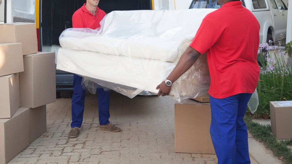 Movers carry a sofa in this undated file photo. 