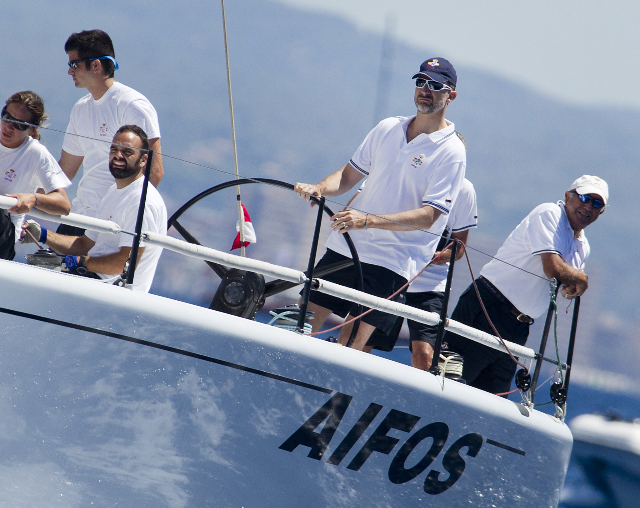 PHOTO: Spain's Crown Prince Felipe, second right, steers the Aifos sailboat during the 32nd Copa del Rey Regatta off the coast of Palma de Mallorca on July 31, 2013. 