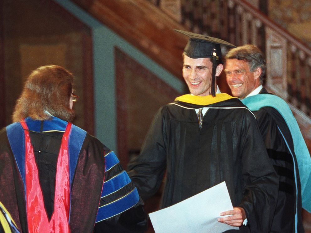 PHOTO: Prince Felipe (C) of Spain is congratulated by Dr. Sally Anne Baynard (L), a lecturer at Georgetown University, and Dean of Foreign Service Peter Krogh (R) at Georgetown University, May 26, 1995.