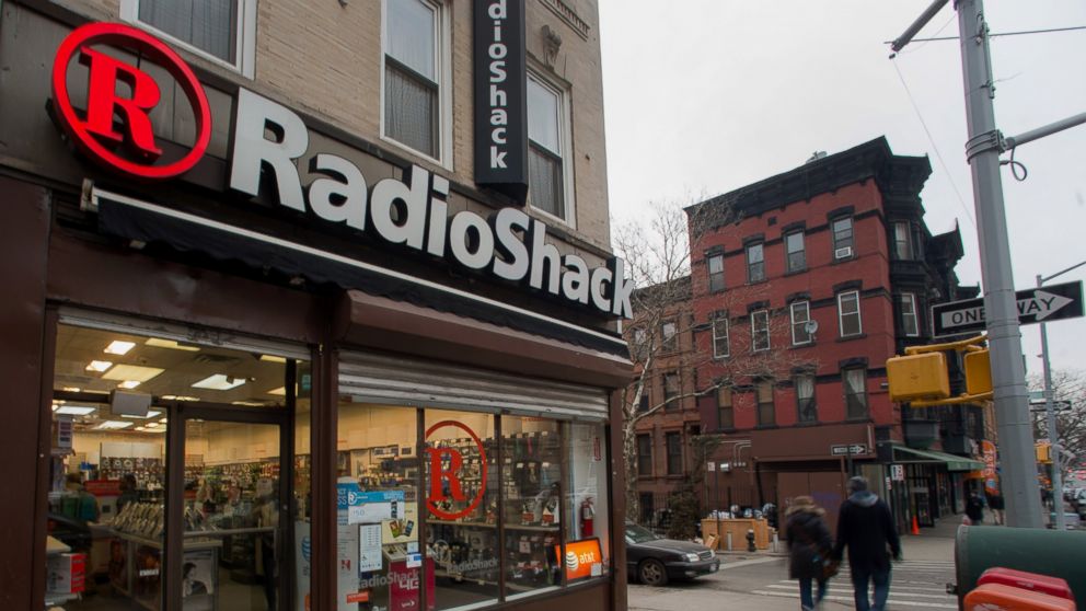 Pedestrians pass in front of a RadioShack Corp. store in New York on March 2, 2014. 