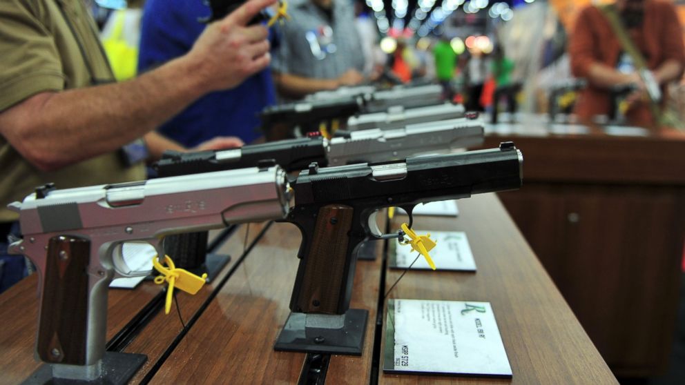Convention goers look at various models of Ruger 1911 model semi-automatic pistols during the National Rifle Association convention at the George R. Brown Convention Center May 4, 2013 in Houston, Texas.