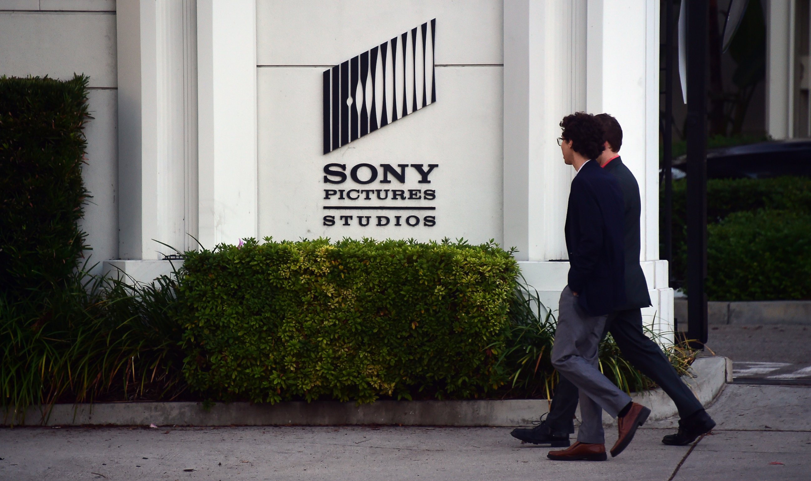 PHOTO: Pedestrians walk past an exterior wall to Sony Pictures Studios in Los Angeles, Calif. on Dec. 4, 2014.