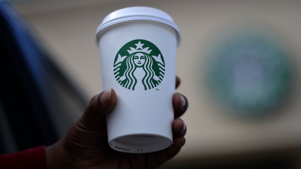 A woman holds a Starbucks coffee cup in this file photo, March 28. 2013, in Silver Spring, Md.
