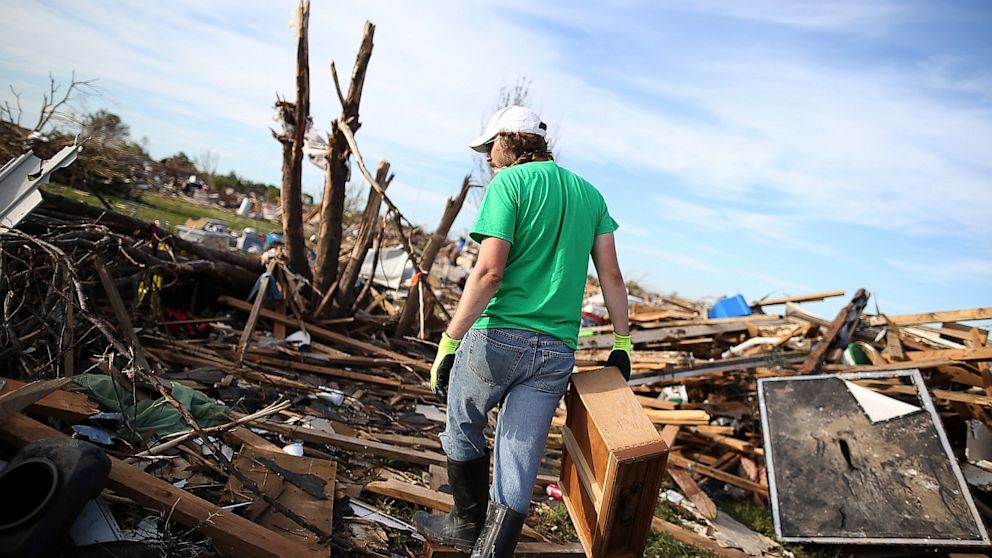 Brian Vitsmun sorts through debris at his home that was destroyed by a tornado on June 2, 2013 in Moore, Okla.