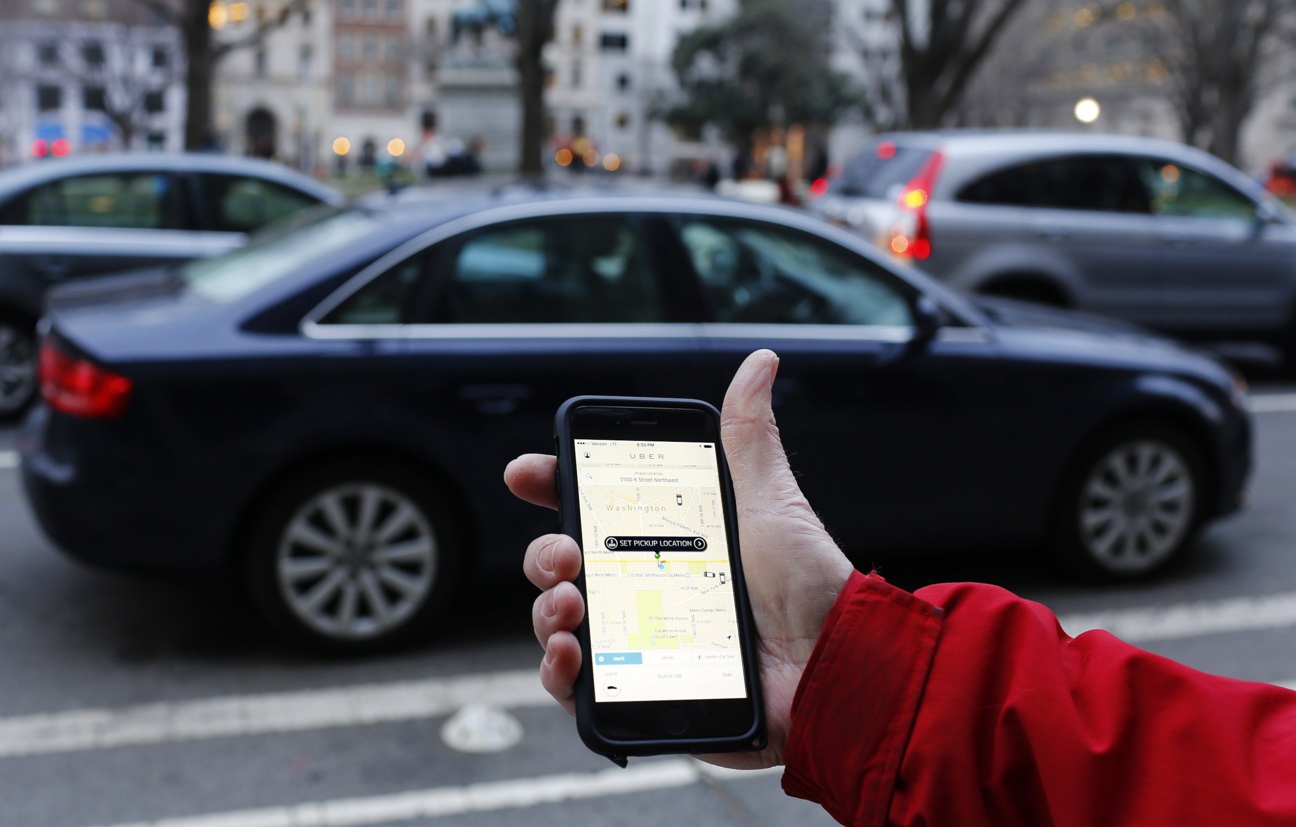 PHOTO: An UBER application is shown as cars drive by in Washington, DC on March 25, 2015.