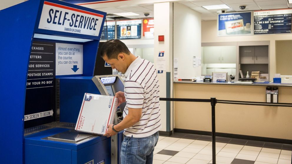 A man uses a self service machine at a United States Post Office (USPS) on Sept. 25, 2013 in New York City. 