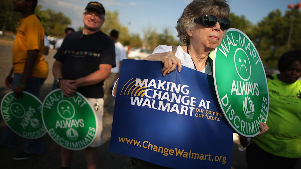 Demonstrators rally before marching and blocking traffic at a major intersection outside a Walmart store in Hyattsville, Md., Sept. 5, 2013.