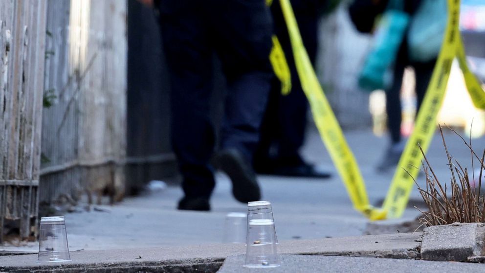 PHOTO: Plastic cups cover empty bullet shell casings at the scene of a shooting that left multiple people injured in the Flatbush neighborhood of the Brooklyn borough of New York, April 6, 2021.