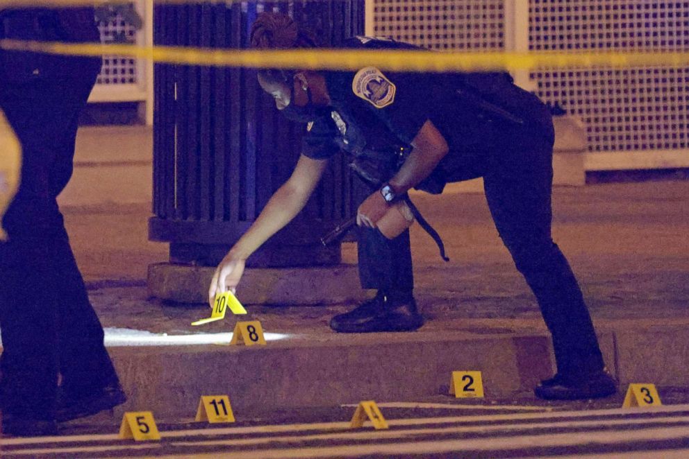 PHOTO: A member of the Washington Metropolitan Police Department puts down markings for bullet casings at the scene of a shooting in Washington, July 17, 2021.