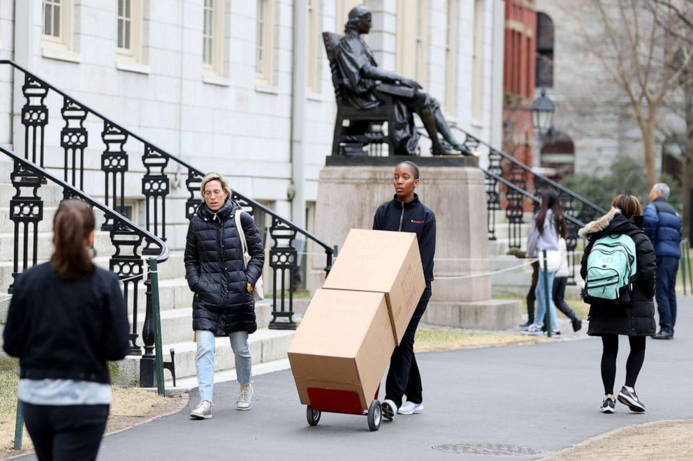 PHOTO: Sophomore Sadia Demby moves her belongings through Harvard Yard on the campus of Harvard University on March 12, 2020 in Cambridge, Mass., after students were asked to move out of their dorms due to the risk of coronavirus.