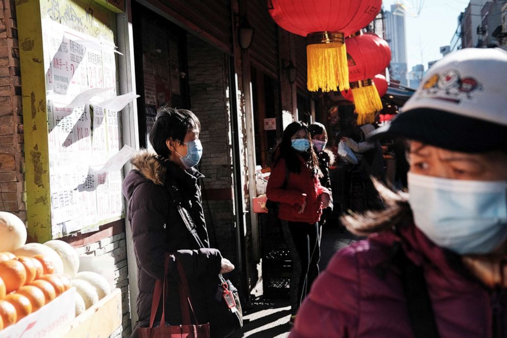 PHOTO: People walk through the streets of Chinatown neighborhood of New York, March 02, 2021.