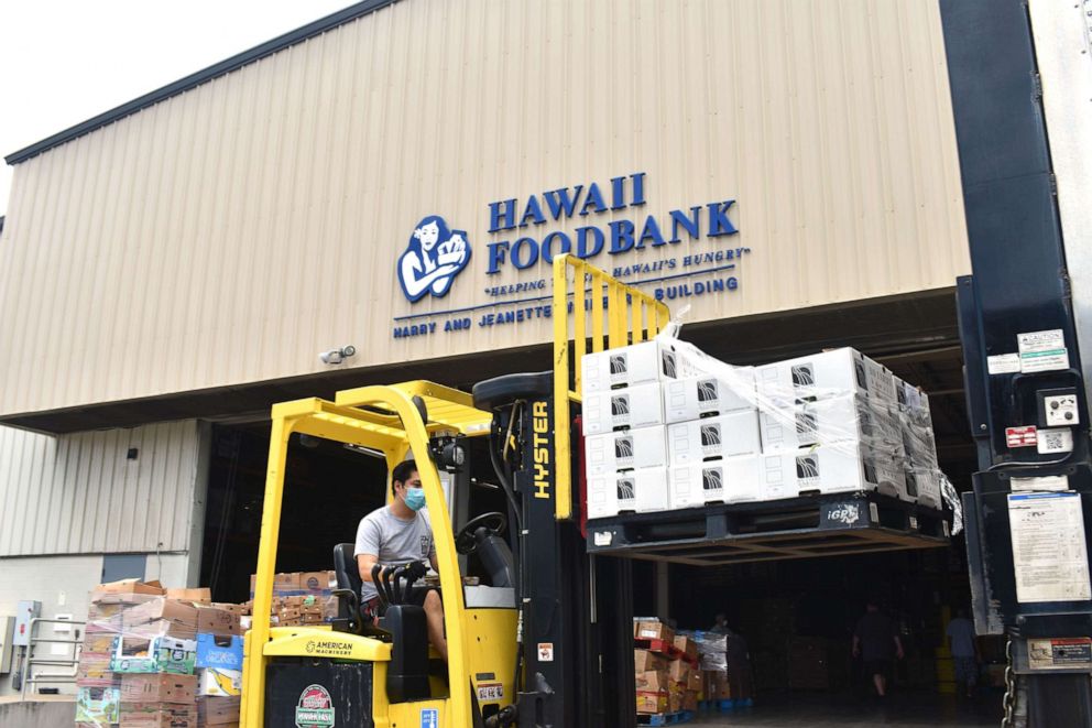 PHOTO: A volunteer at the Hawaii Foodbank distributes food amid the COVID-19 crisis. 