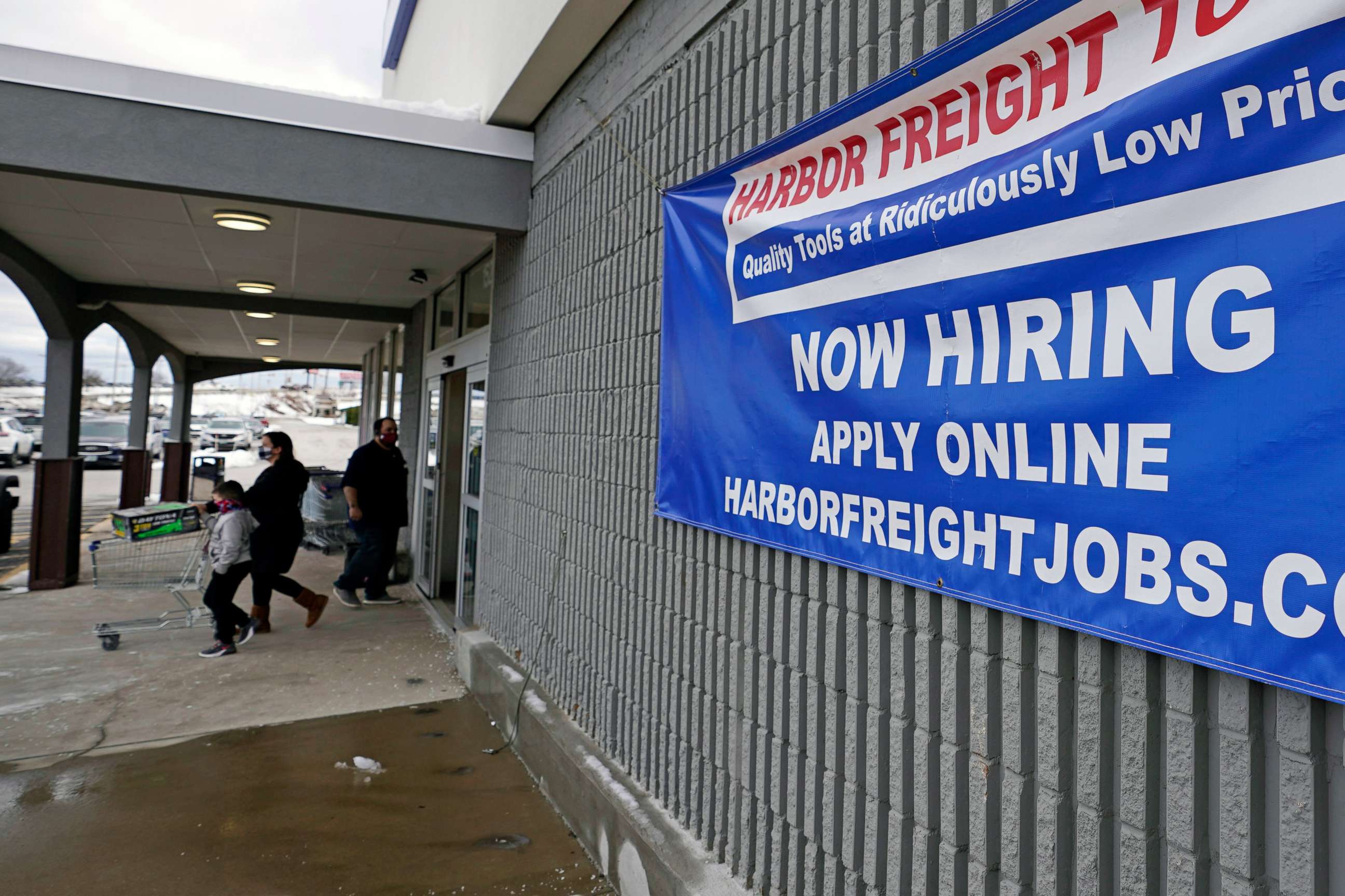 PHOTO: A "Now Hiring" sign hangs on the front wall of a Harbor Freight Tools store in Manchester, N.H., Dec. 10, 2020.
