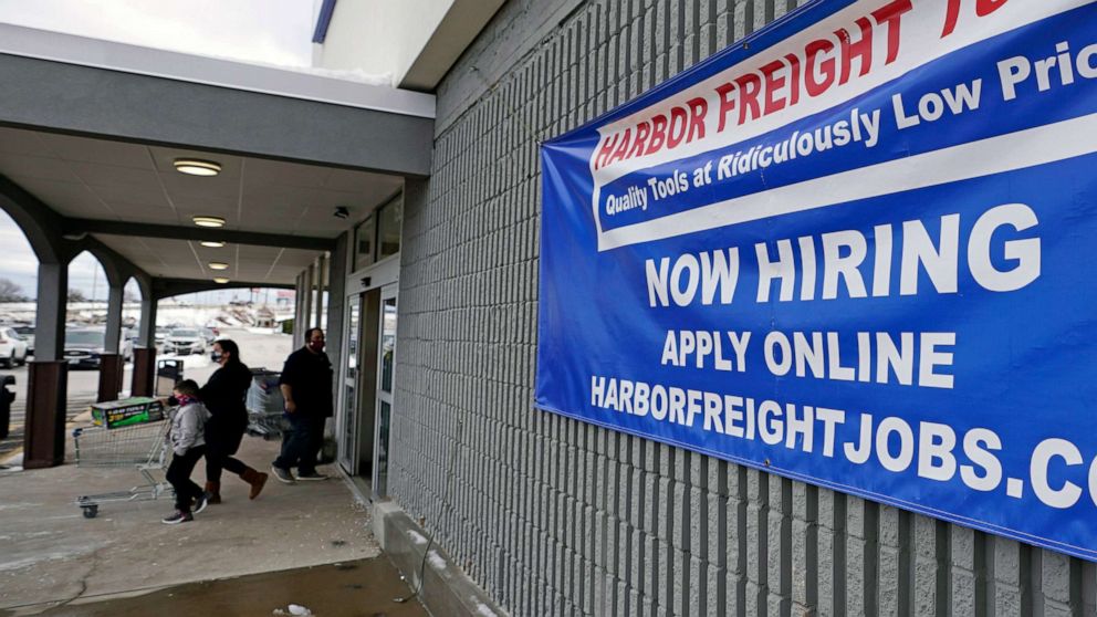 PHOTO: A "Now Hiring" sign hangs on the front wall of a Harbor Freight Tools store in Manchester, N.H., Dec. 10, 2020.