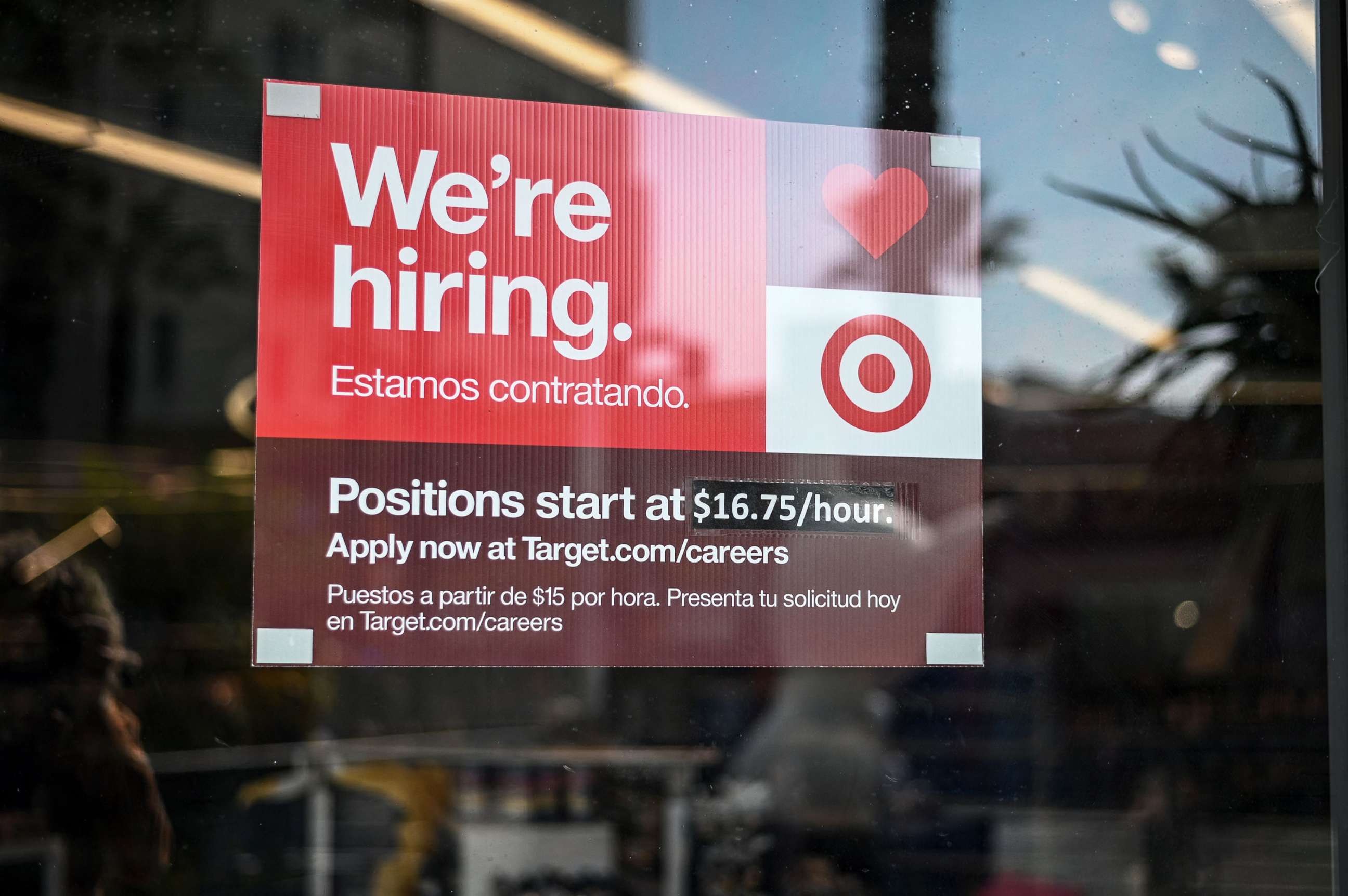 PHOTO: A sign advertising for new employees with an updated starting salary of $16.75 per hour is seen in the window of a Target store in Hollywood, Calif., Nov. 9, 2021.