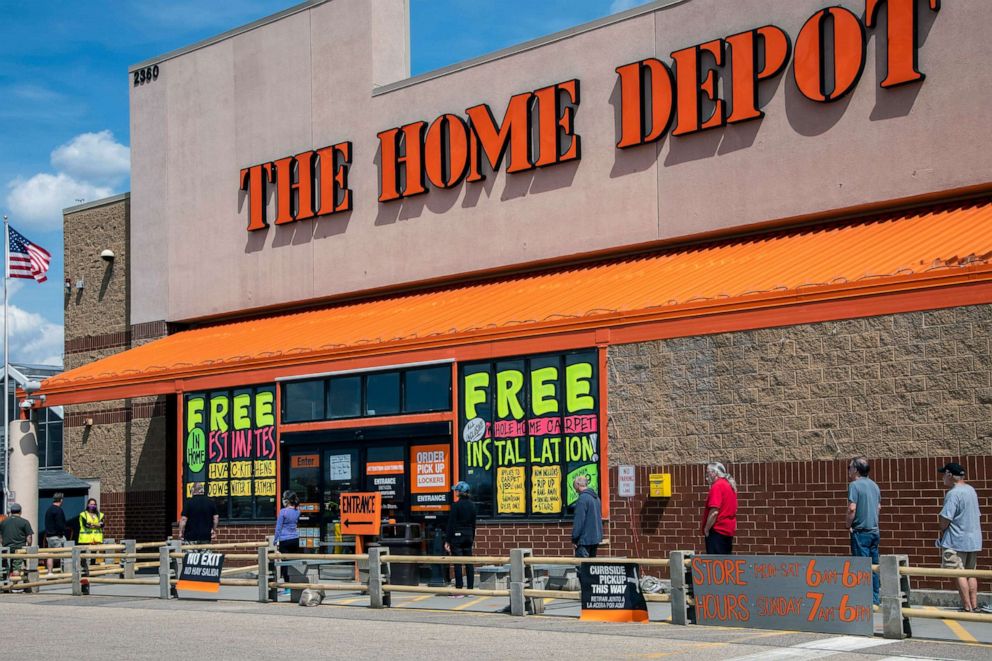 PHOTO:  Customers use social distancing while waiting in line outside The Home Depot in Maplewood, Minn, April 26, 2020. 