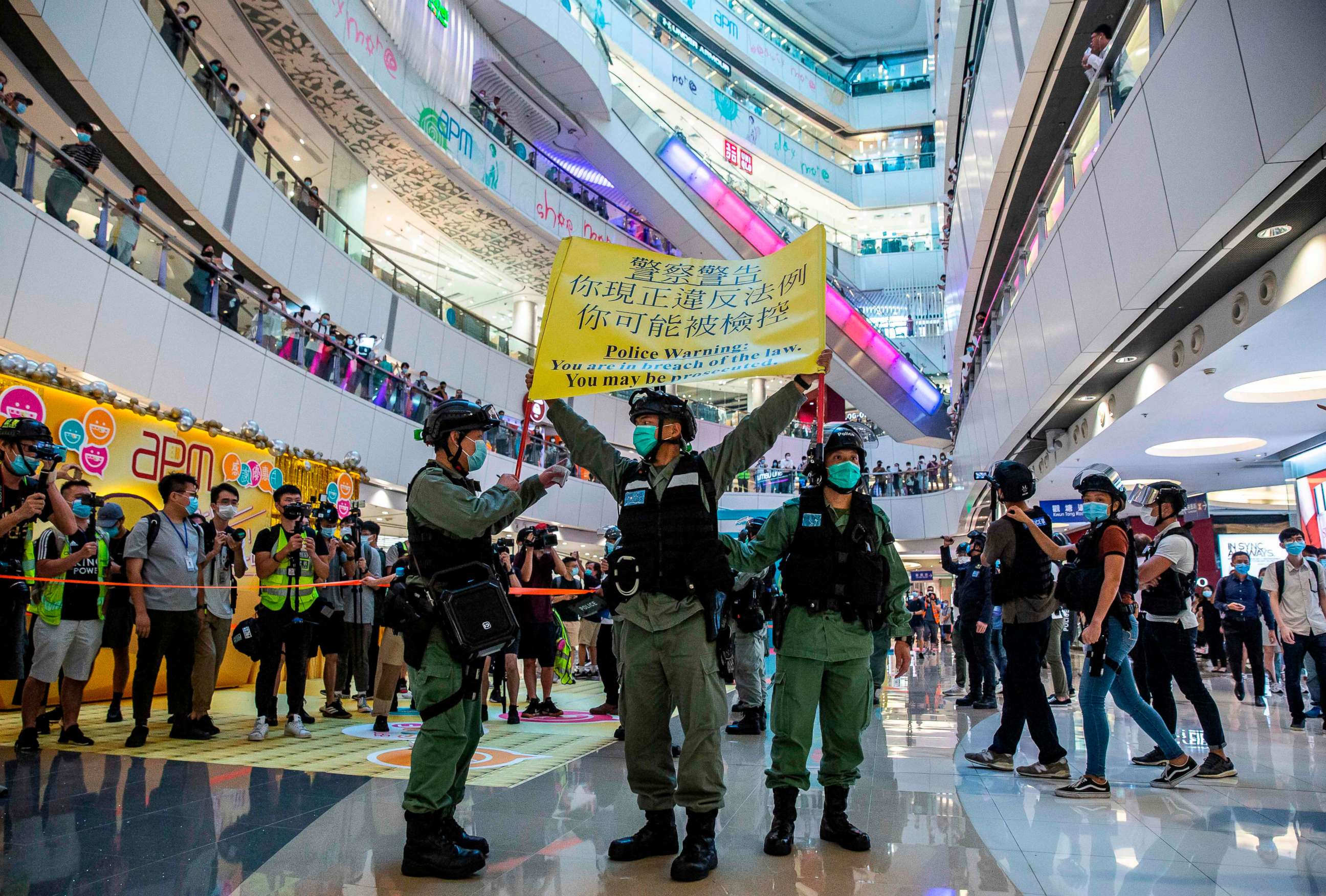 PHOTO: Riot police hold up a warning flag during a demonstration in a mall in Hong Kong on July 6, 2020, in response to a new national security law.