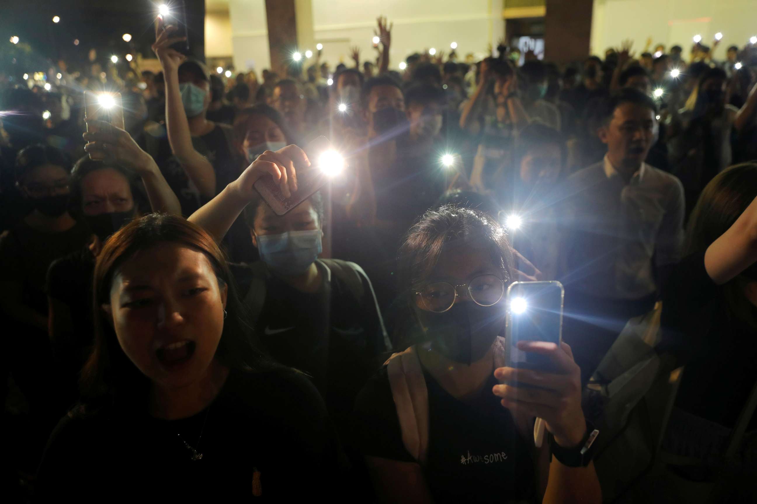 PHOTO: People hold up their phones at a memorial site for a teenage female protester, whom protesters claim was killed by police, at Sheung Shui district in Hong Kong, Oct. 11, 2019.