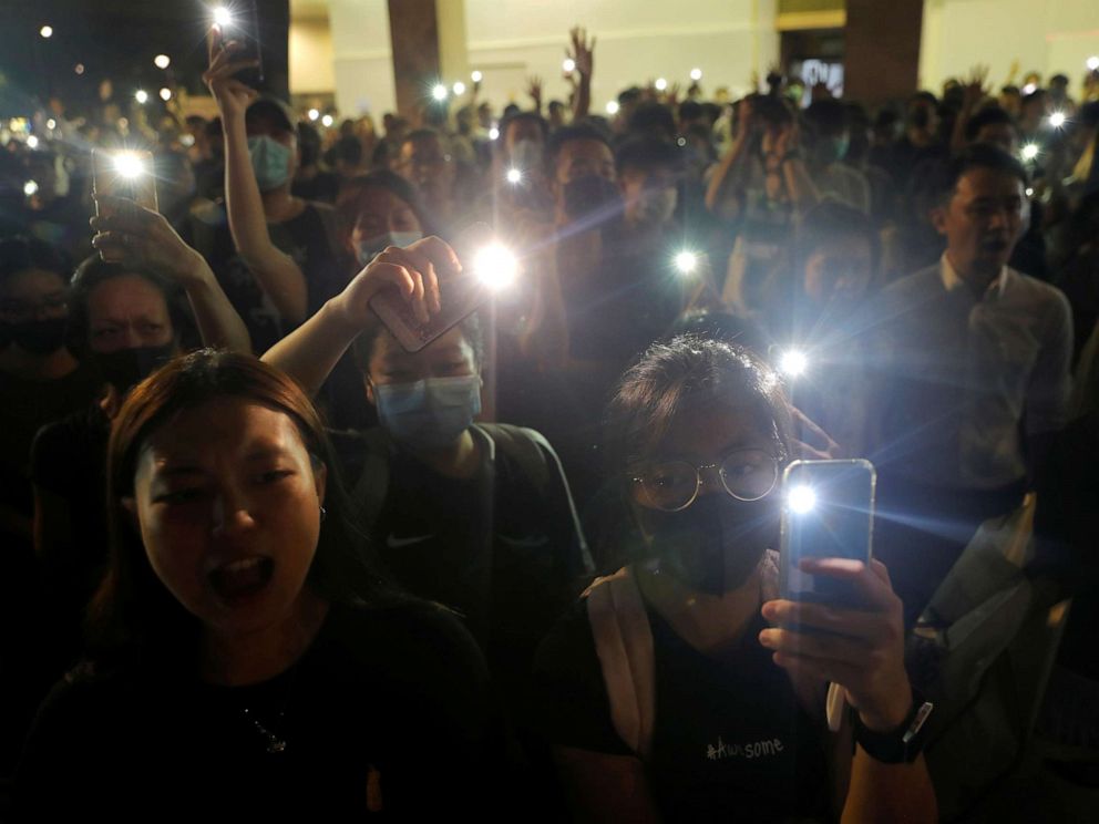 PHOTO: People hold up their phones at a memorial site for a teenage female protester, whom protesters claim was killed by police, at Sheung Shui district in Hong Kong, Oct. 11, 2019.
