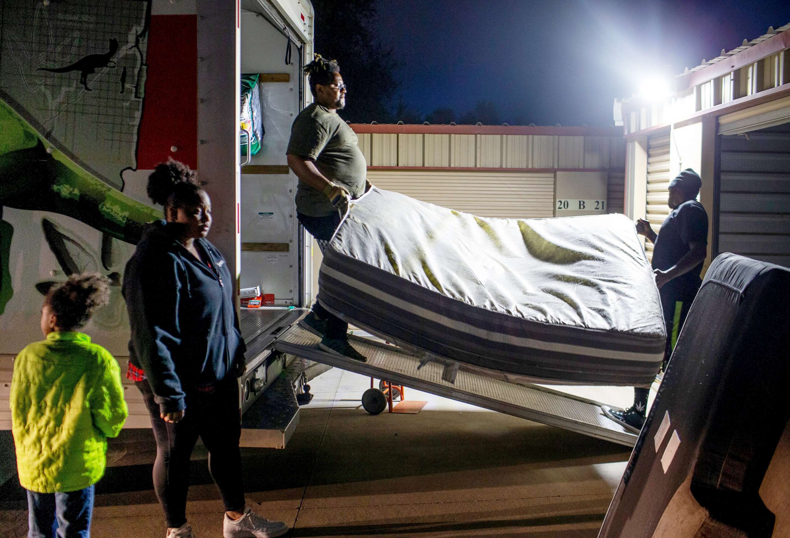 PHOTO: Khalia Rowe-Haysbert and her aunt Amari Haysbert move their belongings into a storage unit after being evicted from their home with help from family friends in Phoenix, on March 11, 2021.