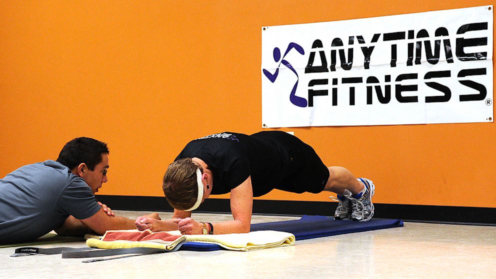 With her trainer, Dave Candra at her side, Betty Sweeney, 71, of Plover, Wis. unofficially breaks the Guinness World Record for holding the plank position, an abdominal exercise on September 28, 2011. 