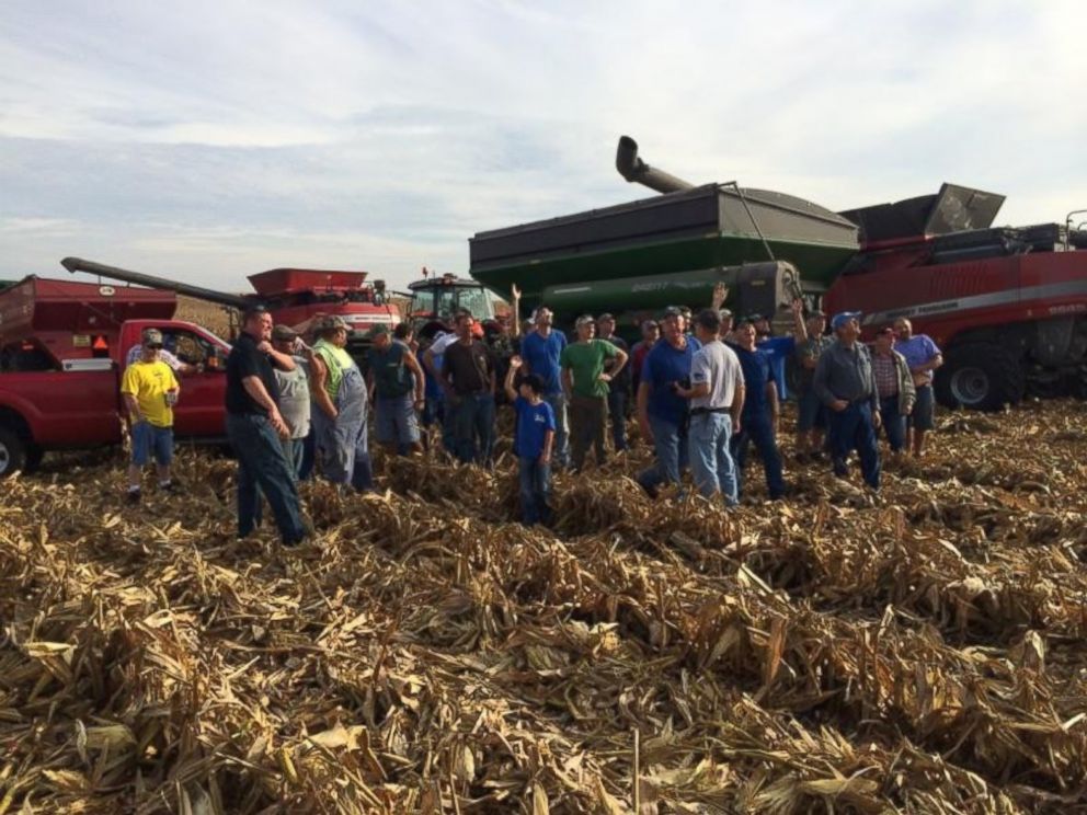 PHOTO: Farmers gather to help harvest Carl Bates' corn crop on September 25, 2015 in Galva, Illinois.